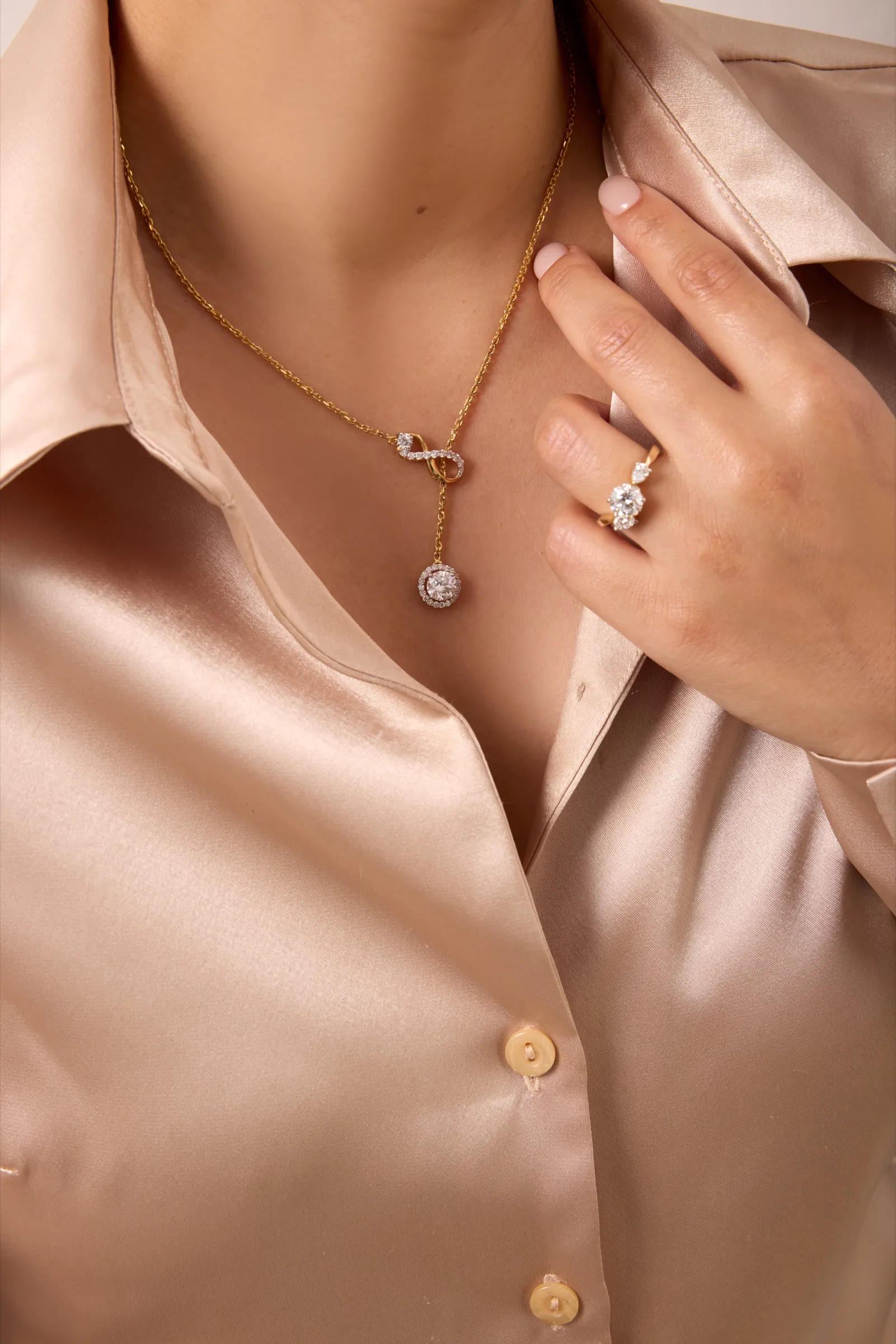 Pearl necklace resting on champagne satin